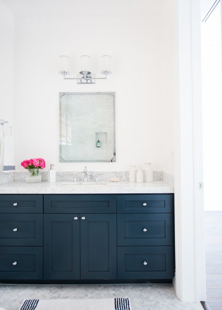 Studio McGee bathroom with Hale Navy cabinets and white walls.
