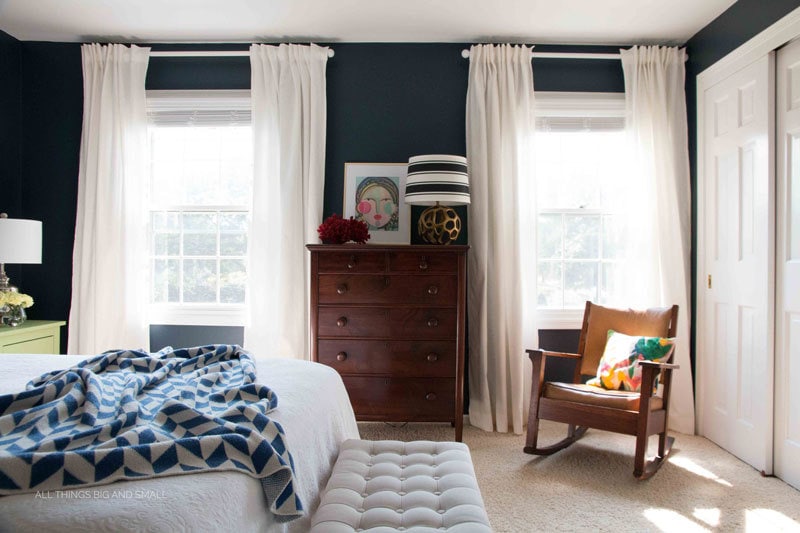 bedroom with Hale Navy walls and white curtains.