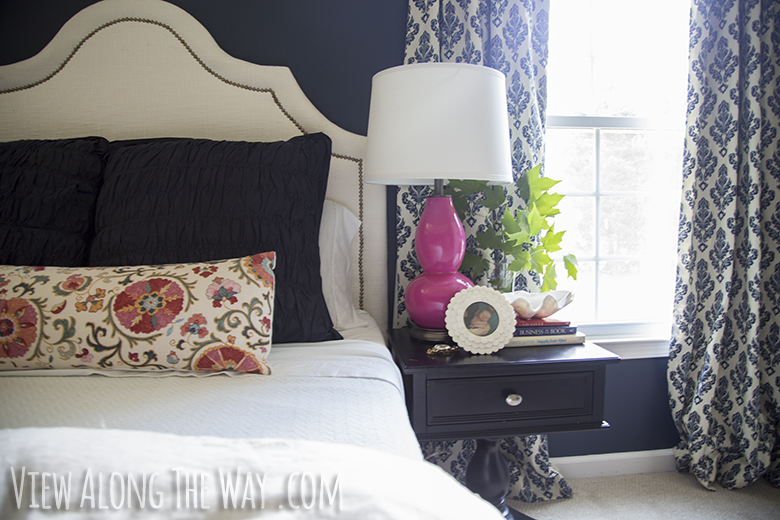 feminine bedroom with hale navy walls.