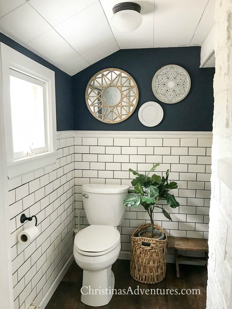 bathroom with white subway tile, gray grout and Hale Navy on the painted half wall.