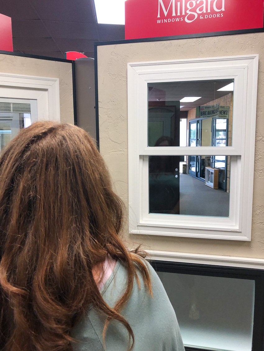 Woman looking at a Trinsic Series window from Milgard