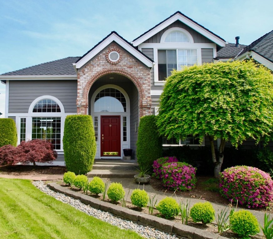 Kendall Charcoal on the exterior of a house with brick and white trim accents