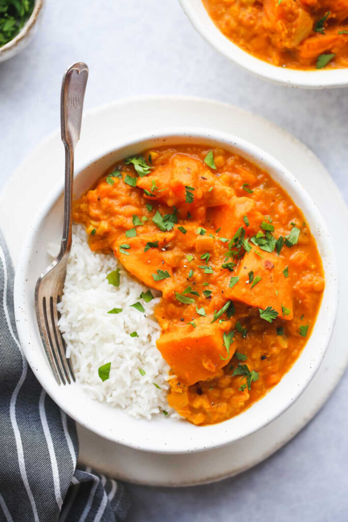 Bowl of instant pot potatp curry in a bowl with white rice.