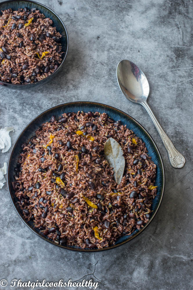 Bowl of black beans and rice on a gray background