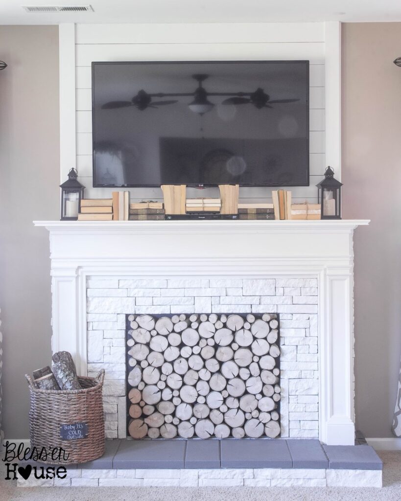 white DIY fireplace with stacked log insert